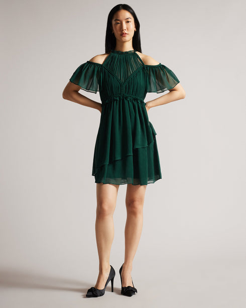 POPPIO-Dresses-Turn heads in POPPIO. Crafted from a lightweight material with a slightly sheer effect, this playful mini dress features a tiered skirt and braided trims that accentuate the look. Pair it with statement jewellery for added drama.The fabric of this product is made with 55% recycled polyester. Using recycled polyester helps divert plastic waste from ending in landfills. Mini dress Rope details High neck Short sleeves Cold shoulder Tiered skirt Concealed fastening Chae is 5'9.5" / 1.77m and wear